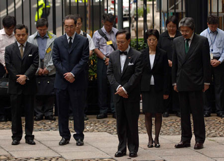 Donald Tsang Yam-kuen (C, Front), chief executive of the HKSAR and other officials mourn during a suspension at the government headquarterse in Hong Kong, south China, May 19, 2008