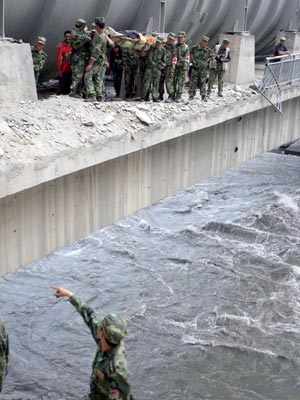 Soldiers carry an injured in the quake-hit Maoxian County, southwest China's Sichuan Province, May 18, 2008. Soldiers from the Chengdu Military Area rescued people injured in the 8.0-magnitude quake hitting southwest China's Sichuan Province on May 12, at more than 10 villages of Nanxin Town in Maoxian County from May 14 to 18. (Xinhua/Gao Xiaowen)