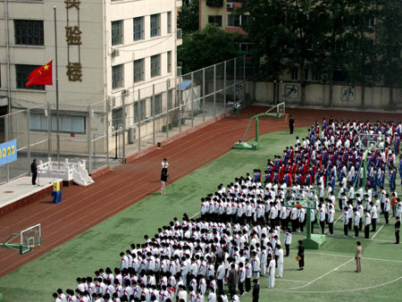 Students attend a silent tribute to the people killed in the earthquake at a middle school in Beijing, capital of China, May 19, 2008.