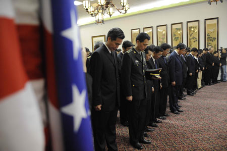 Staff members of the Chinese Embassy to the United States mourn for the quake victims during a silent tribute in Washington, capital of the United States, May 19, 2008. China began on May 19 a three-day mourning for the victims of the 8.0-magnitude quake hitting southwest and northwest China on May 12. (Xinhua/Zhang Yan)