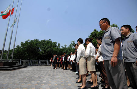 Employees of a hotel mourn during a silent tribute in Mianzhu, the quake-hit southwest China's Sichuan Province, May 19, 2008.