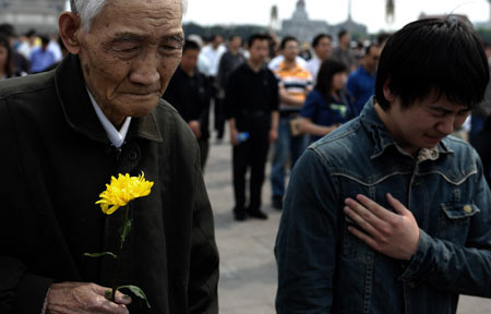 Duan Jinsheng (L), 83, and Cai Xiaoyu (R), a student of Renmin University, mourn during a silent tribute in Tian'anmen Square in central Beijing, capital of China, May 19, 2008.