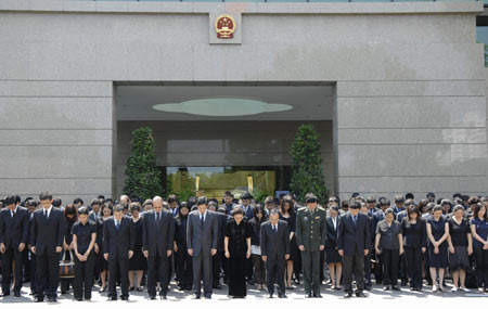 Chinese people mourn for quake victims during a silent tribute at the Chinese Embassy in Singapore May 19, 2008. China began on May 19 a three-day mourning for the victims of the 8.0-magnitude quake hitting southwest and northwest China on May 12.