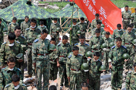 Soldiers mourn during a silent tribute at the rescue site in Yinhua town of Shifang, southwest China's Sichuan Province, May 19, 2008. China began on May 19 a three-day mourning for the victims of the 8.0-magnitude quake hitting southwest and northwest China on May 12.