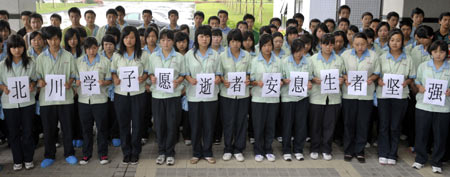 Intern students of Beichuan Vocational School mourn during a silent tribute in Liaobu town of Dongguan, south China's Guangdong Province, May 19, 2008. China began on May 19 a three-day mourning for the victims of the 8.0-magnitude quake hitting southwest and northwest China on May 12.