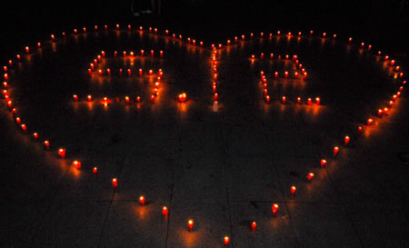 Citizens mourn around candles during a memorial ceremony in Nanchang, east China's Jiangxi Province, May 19, 2008. China began on Monday a three-day mourning for the victims of the 8.0-magnitude quake on Richter scale hitting southwest and northwest China on May 12.