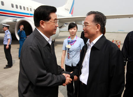 Chinese Premier Wen Jiabao (R) greets President Hu Jintao upon Hu's arrival in Mianyang, a city in quake-hit southwestern Sichuan Province, May 16, 2008. President Hu flew to quake-hit southwestern Sichuan Province Friday morning to console the victims and inspect the rescue and relief work.