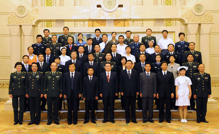 Li Changchun (6th L, 1st row), a member of the Standing Committee of the Political Bureau of the Communist Party of China (CPC) Central Committee, and Chinese Vice President Xi Jinping (7th L, 1st row), also member of the Standing Committee of the Political Bureau of the CPC Central Committee, pose for a group photo with quake-relief model workers before the first lecture on the heroic deeds and thoughts in quake relief efforts, in Beijing, capital of China, June 11, 2008. (Xinhua/Li Tao)