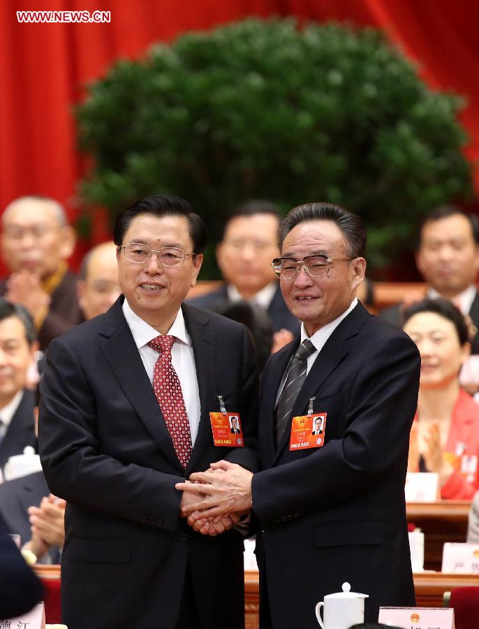 Wu Bangguo (R) shakes hands with Zhang Dejiang after Zhang was elected chairman of the 12th National People's Congress (NPC) Standing Committee at the fourth plenary meeting of the first session of the 12th NPC in Beijing, capital of China, March 14, 2013. (Xinhua/Pang Xinglei) 