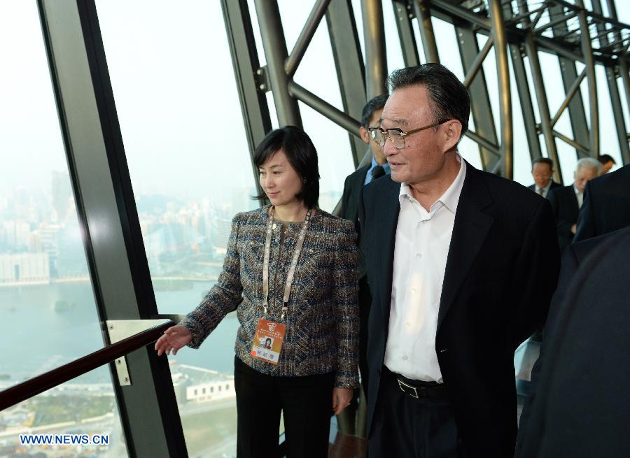 Wu Bangguo (R), chairman of the National People's Congress (NPC) Standing Committee, listens to the introduction on the city planning in Macao Tower in Macao, south China, Feb. 21, 2013. 