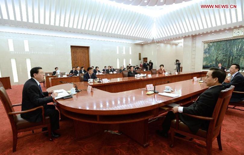 Zhang Dejiang (L), executive chairperson of the presidium of the first session of the 12th National People's Congress (NPC), presides over the fourth meeting of the presidium's executive chairpersons at the Great Hall of the People in Beijing, capital of China, March 13, 2013. (Xinhua/Ma Zhancheng)