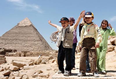 Children play at the Giza pyramids in Cairo, capital city of Egypt, April 25, 2007. Egypt entered its midseason of tourism from April, more and more tourists from all over the world came here to feel its ancient culture.(Xinhua Photo/Lin Yiguang)