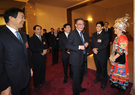 Chinese leaders underscored the importance of relying on the people in the combat against the global financial turmoil, urging efforts to ensure their well-being, when joining lawmakers and political advisors in panel discussions Friday.