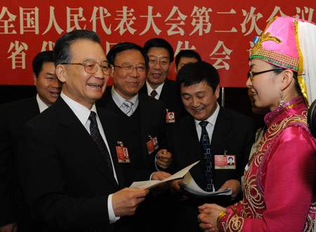 Chinese leaders underscored the importance of relying on the people in the combat against the global financial turmoil, urging efforts to ensure their well-being, when joining lawmakers and political advisors in panel discussions Friday.