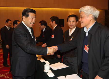 Chinese leaders underscored the importance of relying on the people in the combat against the global financial turmoil, urging efforts to ensure their well-being, when joining lawmakers and political advisors in panel discussions Friday.