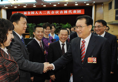 Chinese leaders underscored the importance of relying on the people in the combat against the global financial turmoil, urging efforts to ensure their well-being, when joining lawmakers and political advisors in panel discussions Friday.