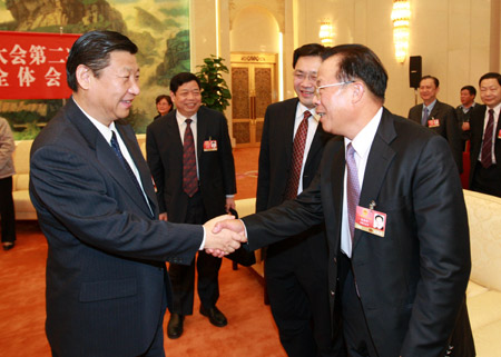 Chinese leaders underscored the importance of relying on the people in the combat against the global financial turmoil, urging efforts to ensure their well-being, when joining lawmakers and political advisors in panel discussions Friday.