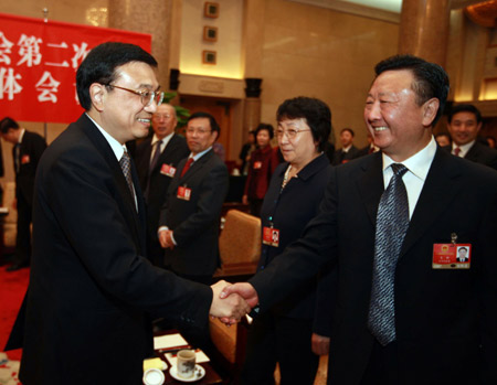 Chinese leaders underscored the importance of relying on the people in the combat against the global financial turmoil, urging efforts to ensure their well-being, when joining lawmakers and political advisors in panel discussions Friday.