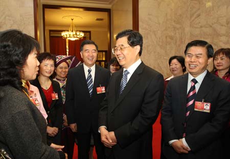 Chinese President Hu Jintao (front, 2nd R) talks to female deputies during the panel discussion of deputies to the Second Session of the 11th National People's Congress (NPC) from south China’s Guangdong Province as International Women's Day is coming, in Beijing, capital of China, March 7, 2009. (Xinhua/Lan Hongguang) 