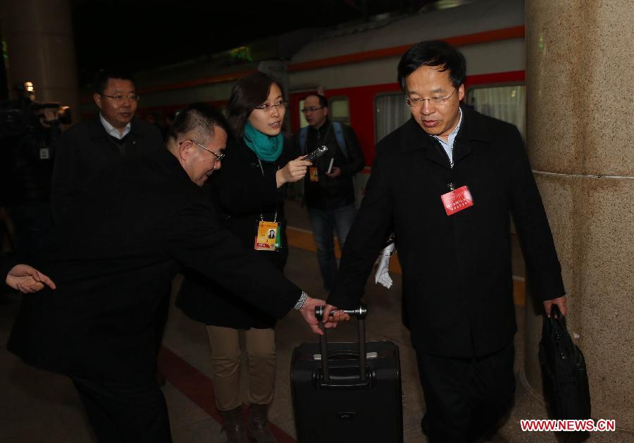 Xing Yongming(1st R), deputy to the 12th National People's Congress (NPC) from north China's Inner Mongolia Autonomous Region, receives an interview upon his arrival in Beijing, capital of China, March 2, 2014. The second session of 12th NPC, the national legislature, is scheduled to open in Beijing on March 5. (Xinhua/Jin Liwang) 