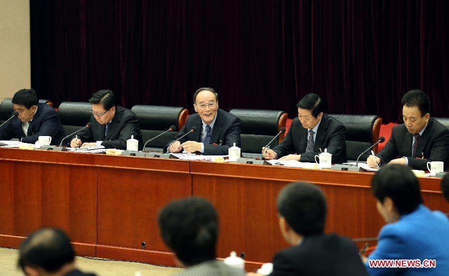Wang Qishan (C rear), a member of the Standing Committee of the Political Bureau of the Communist Party of China (CPC) Central Committee and secretary of the CPC Central Commission for Discipline Inspection, joins a discussion with deputies to the 12th National People's Congress (NPC) from southwest China's Sichuan Province during the second session of the 12th NPC, in Beijing, capital of China, March 11, 2014. (Xinhua/Yao Dawei)