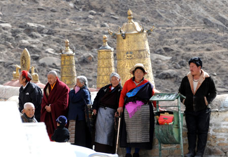Buddhism followers watch a Buddhist ceremony at the Zhaibung Monastery in the suburb of Lhasa, capital of southwest China's Tibet Autonomous Region, March 4, 2009.