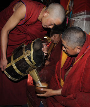Tibetan Buddhists donate tea at the Zhaibung Monastery in the suburb of Lhasa, capital of southwest China's Tibet Autonomous Region, March 4, 2009.