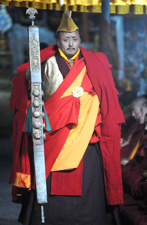 A Tibetan Buddhist holds a pontil to keep order during a Buddhist ceremony at the Zhaibung Monastery in the suburb of Lhasa, capital of southwest China's Tibet Autonomous Region, March 4, 2009.