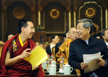 The 11th Panchen Lama, Bainqen Erdini Qoigyijabu, talks with Xu Jialu, former vice-chairman of the Standing Committee of the National People's Congress of China, before the opening ceremony of the Second World Buddhist Forum (WBF) in Wuxi, east China's Jiangsu Province on March 28, 2009.