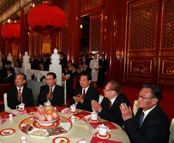 Chinese President Hu Jintao (C), flanked by former president Jiang Zemin (2nd R) and other senior leaders, applauds as they watch the grand gala celebrating the 60th anniversary of the founding of the People's Republic of China, on the Tian'anmen Rostrum in central Beijing, capital of China, Oct. 1, 2009. (Xinhua/Ju Peng)