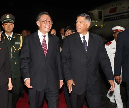 Wu Bangguo (2nd L), chairman of the Standing Committee of China's National People's Congress(NPC), the country's top legislature, talks with President of National Assembly of Madagascar Jacques Sylla (R) upon his arrival in Antananarivo, capital of Madagascar, Nov. 11, 2008.