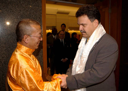 Shingtsa Tenzinchodrak (L), a living Buddha of the Kagyu sect of Tibetan Buddhism, also vice chairman of the Standing Committee of the People's Congress of Tibet Autonomous Region of China, shakes hands with New York State Assemblyman Felix Ortiz in New York, the United States, March 19, 2009. Assemblymen of New York State and New York city had a meeting here with a delegation of Tibetan deputies of China's National People's Congress.
