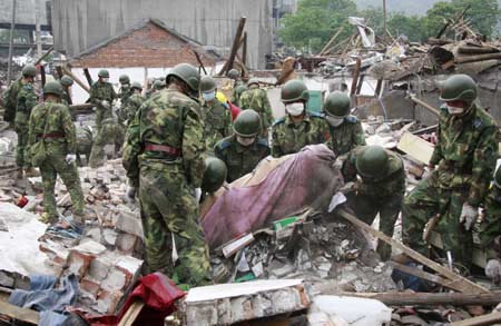 Rescuers search for survivors in debris in quake-hit Hanwang Town of Mianzhu City, southwest China's Sichuan Province, May 17, 2008.