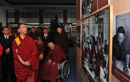 The 11th Panchen Lama Erdeni Gyaincain Norbu (front) looks at the exhibits during an exhibition titled 