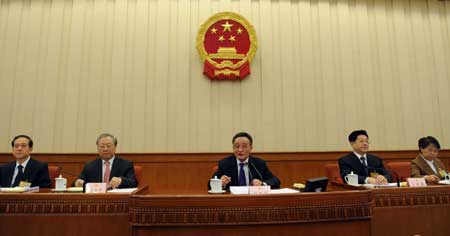 Wu Bangguo (C), chairman of the Standing Committee of the National People's Congress (NPC), presides over the concluding meeting of the 7th meeting of the 11th NPC Standing Committee in Beijing, on Feb. 28, 2009. The NPC Standing Committee, China's top legislature, concluded its four-day session on Saturday, after approving the food safety law, an amendment to the criminal law and the revised insurance law. 
