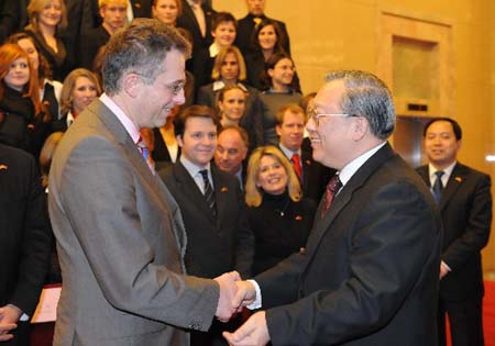 Lu Yongxiang (R), vice-chairman of the Standing Committee of the National People's Congress, China's top legislative body, shakes hands with Gerd Otto Hoofe, state secretary of the Ministry of Youth from Germany, in Beijing on Friday, March 28, 2008. (Xinhua Photo)