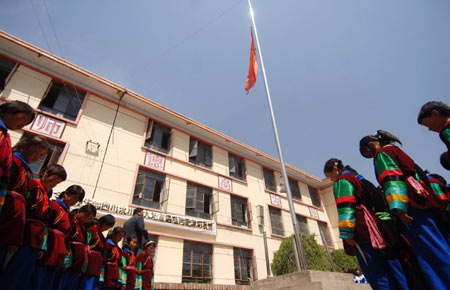 Students and teachers mourn during a silent tribute in Huzhu Tu Autonomous County, northwest China's Qinghai Province, May 19, 2008. 