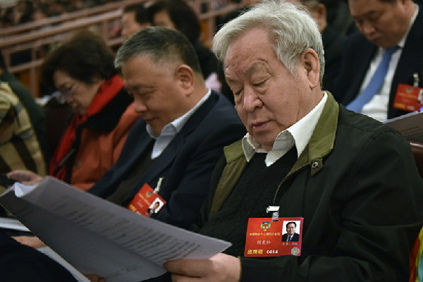 代表在阅读政府工作报告。人民网记者 李毓涵 摄